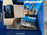 a box of playmobil and other toys in it