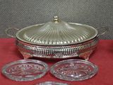 an image of a silver plate and four glass coasters on a red cloth