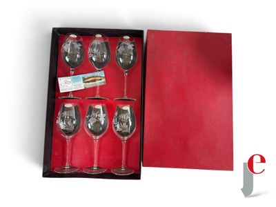 six wine glasses in a box on a table