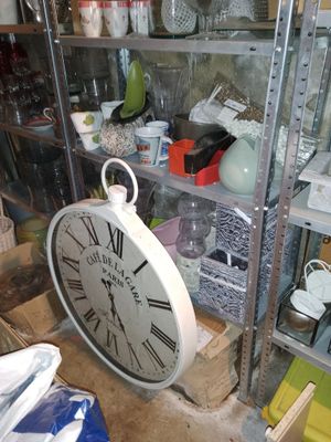 a clock that is sitting on a shelf in a room