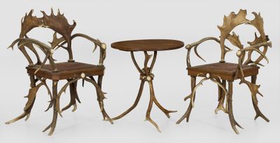 two chairs and a table with antelope antelope on them