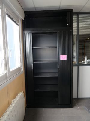 a bathroom with a black cabinet and a white radiator