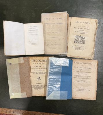several old books sitting on top of a table next to each other