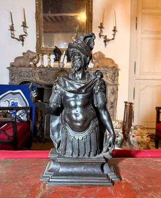 une statue représentant un homme assis sur une table