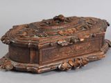 a wooden box with carvings on it sitting on a table