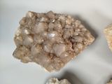 three pieces of rock on a white surface with a small piece of rock in the middle