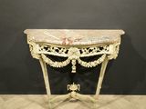 an antique console table with a marble top on a wooden floor