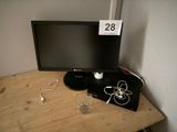 a computer monitor sitting on top of a wooden desk