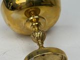 gold plated candle holder with a mirror on top of it