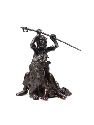 bronze statue of a man on a horse holding a spear