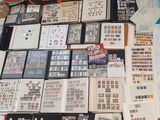 a lot of stamps on a table with a calculator