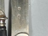 two knives that are next to each other on a table