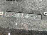 a close up of a metal plate with a number on it