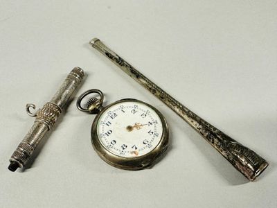 a silver pocket watch, a pen, and a pocket watch on a table