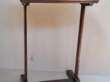 a small wooden table with a glass top on it
