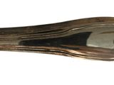 a silver spoon with a handle on it on a white surface