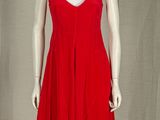 a mannequin wearing a red dress on a mannequin stand