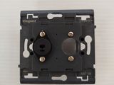 a close up of a black switch on a white wall