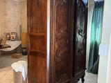 a large wooden cabinet in the middle of a room