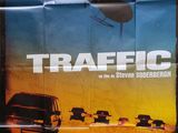 the poster for the movie traffic is displayed on the wall