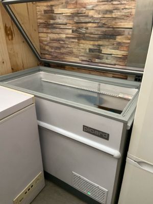 a refrigerator and a freezer in a small room