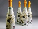 four bottles of champagne with a map on them sitting next to each other