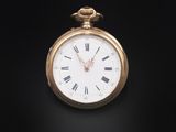 an antique pocket watch with roman numerals on a black background