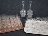 a tray of wine glasses and a decanter on a table