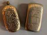 two small silver objects that are sitting on a table