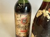 two bottles of wine sitting next to each other on a table