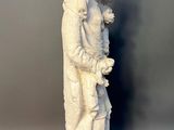white statue of a woman holding a baby in her arms