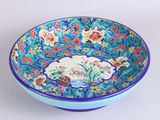 a blue bowl with a floral design on it