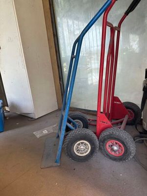 a red and blue hand truck in a garage