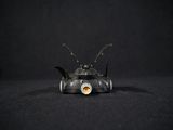 a small toy car with a bat on top of it