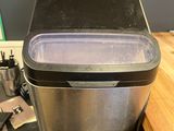 a trash can sitting on top of a desk