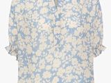 the blouse is blue and white with white flowers on it
