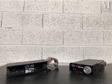 two microphones sitting on a table with a brick wall in the background