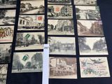 many old postcards on display on a table