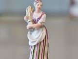 a figurine of a woman standing on a table