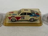 a small toy car sitting on a table next to a plate
