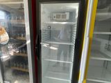 two refrigerators that are open in a store