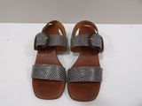 a pair of women ' s sandals on a white surface