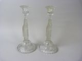 pair of clear glass candlesticks on a white background