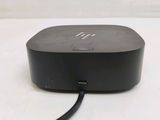 the small black device is connected to the charger on the table