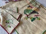 a table cloth with a bird on it and two napkins