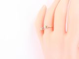 an image of a woman ' s hand with a ring on it