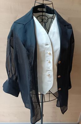 a suit on a mannequin with a white shirt and black jacket