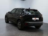a black suv parked in a room with a ceiling fan