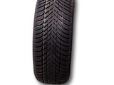 a close up of a tire on a white surface