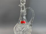 an image of a clear glass bottle with a red lid